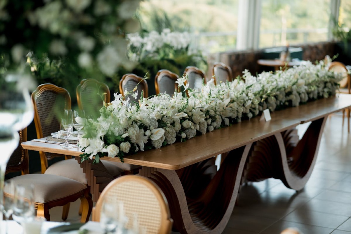 Editorial celebration table installation with white florals, soft candles and blush linens