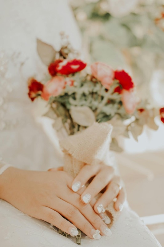 Elegant celebration bouquet with cream garden roses, burgundy accents and trailing ribbon